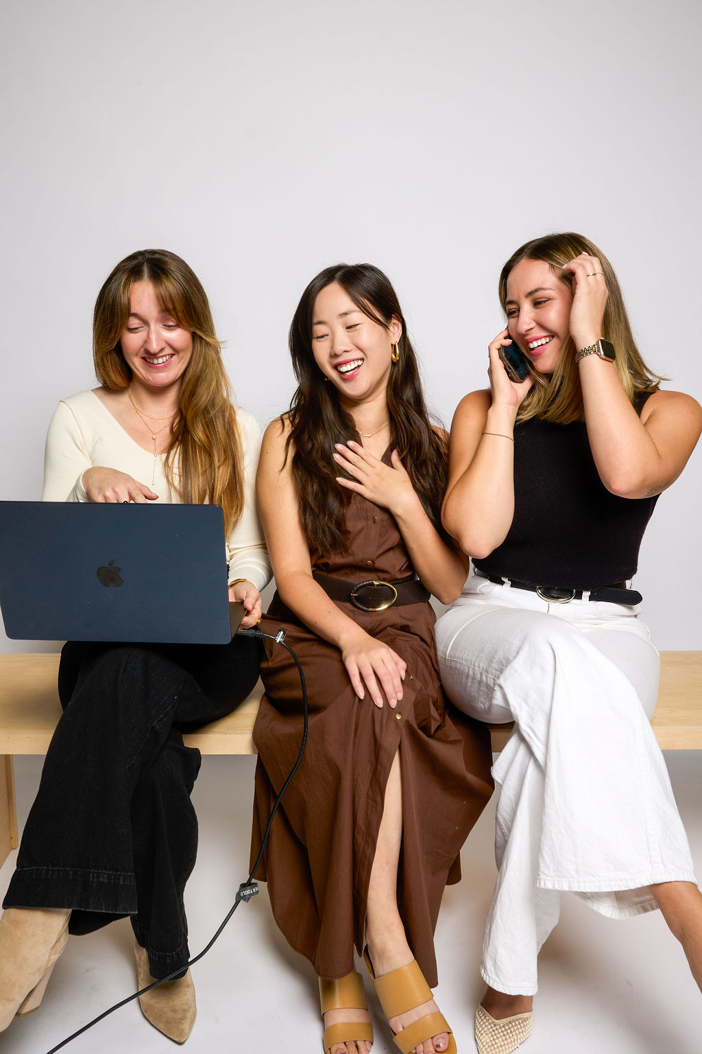 Three colleagues with a laptop in studio