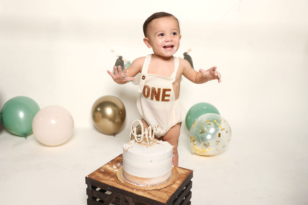 Cake smash in a ONE romper, first birthday