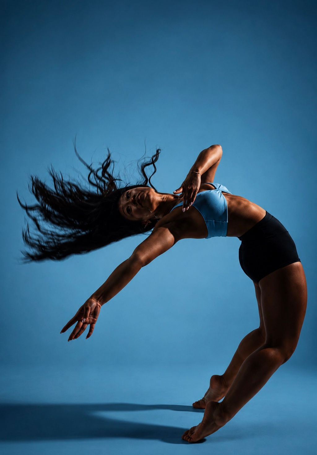 Fitness portrait in a backbend on the studio floor