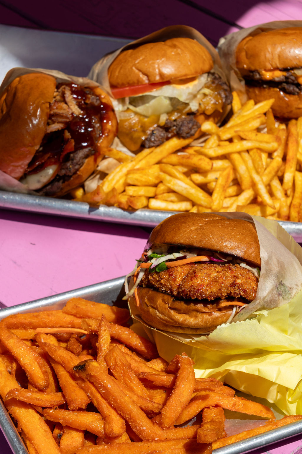Burgers and fries on metal trays